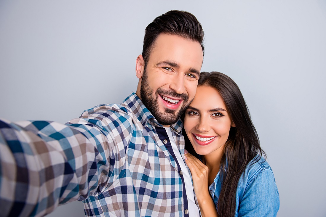 happy couple taking selfie